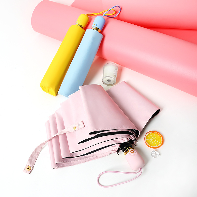 Automatic folding umbrellas with black UV-coated canopies and colorful egg-shaped handles