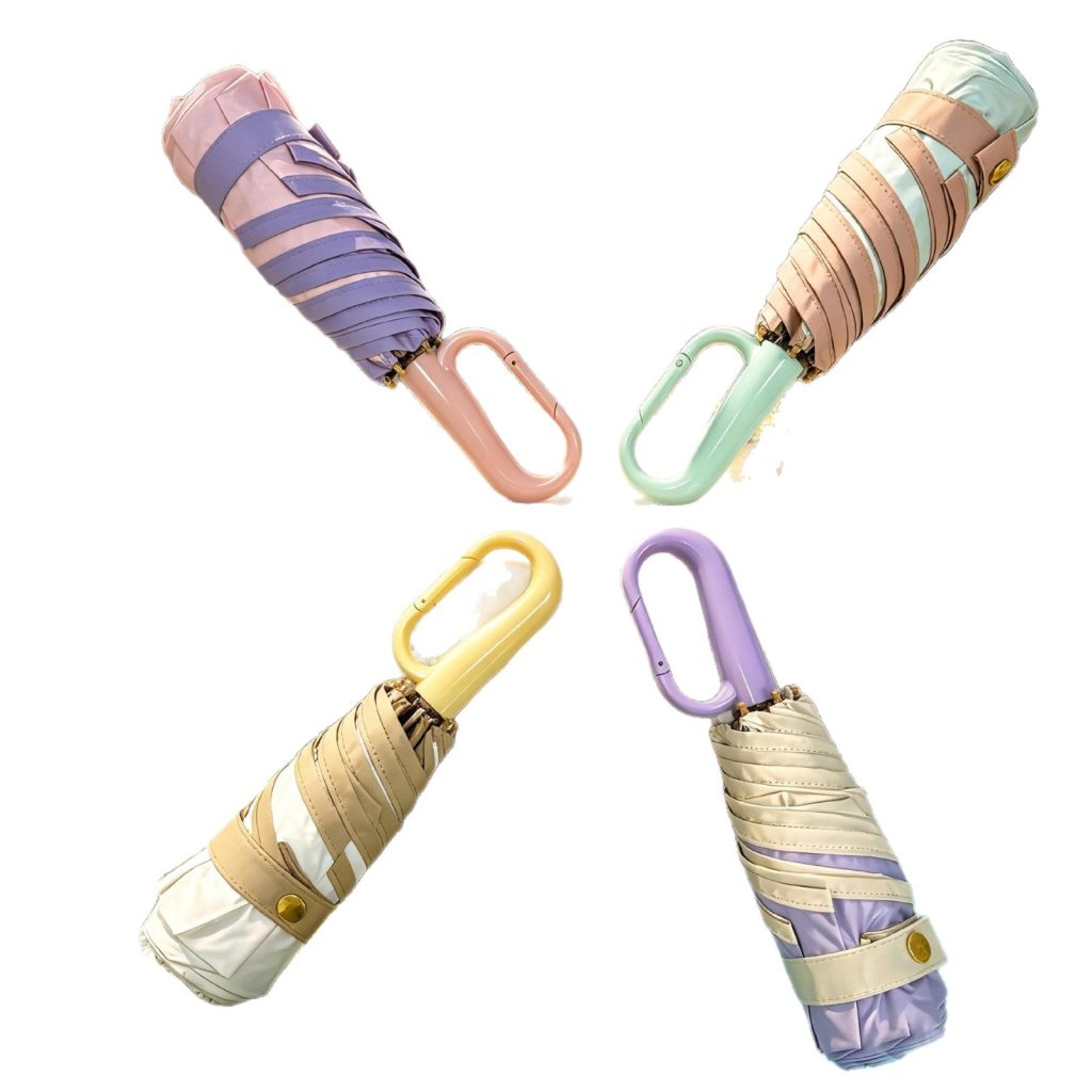 Four folded Japanese style 5-fold compact umbrellas with golden frames, ring handles, and pastel canopies
